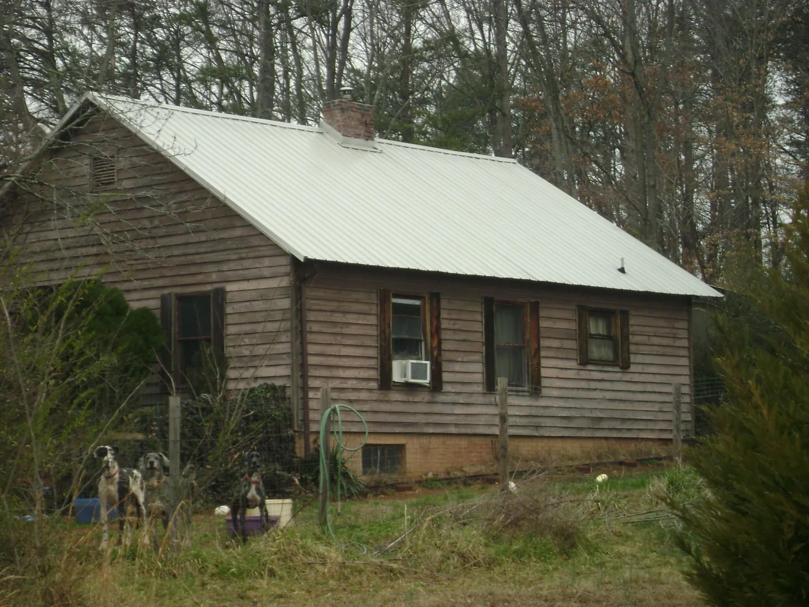White metal roof on an old wood sided farmhouse, from a Metal Roof Installation job in Jenkinsburg
